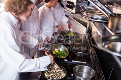 Group of chef preparing food in the kitchen