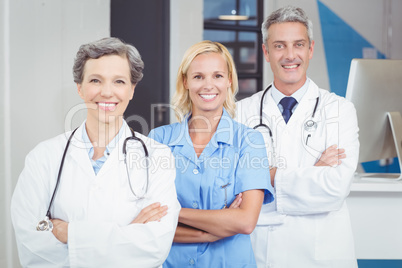 Portrait of smiling doctor team standing with arms crossed