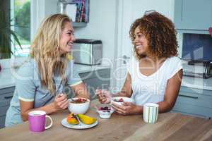 Female friends having breakfast at kitchen table