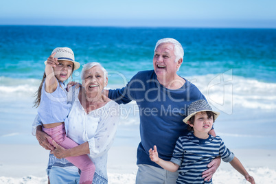 Happy grandparents giving piggy back to children