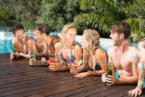 Happy friends enjoying at the swimming pool