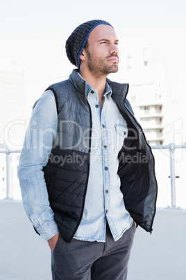 Confident young man wearing beanie hat and jacket