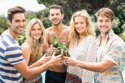 Group of friends toasting their beer bottles