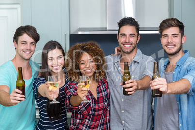 Portrait of multi-ethnic friends showing beer and wine