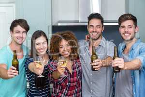 Portrait of multi-ethnic friends showing beer and wine