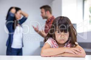 Sad girl hearing her parents arguing
