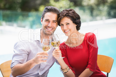 Portrait of smiling couple toasting white wine