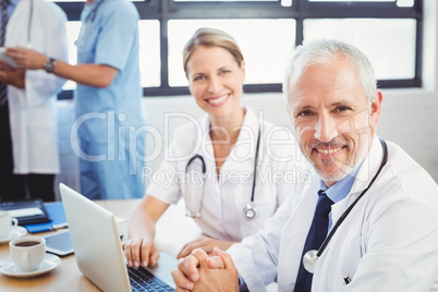 Portrait of two doctors smiling in conference room