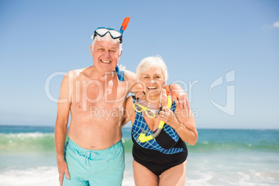 Senior couple wearing snorkel and diving goggles