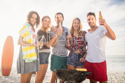 Happy friends having fun around barbecue