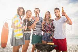 Happy friends having fun around barbecue