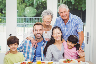 Portrait of smiling multi generation family at dining table Portrait of smiling multi generation family at dining table