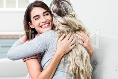 Happy young woman hugging female friend
