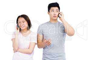 Young couple talking on mobile phone