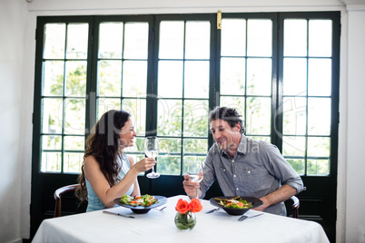 Couple holding wine glass and interacting