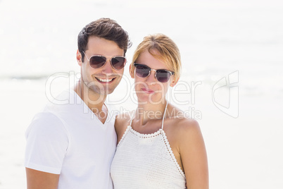 Portrait of young couple in sunglasses at beach Portrait of young couple in sunglasses at beach