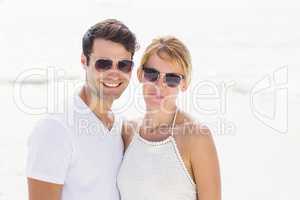 Portrait of young couple in sunglasses at beach