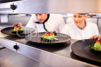 Chef keeping appetizer plate ready on the order station