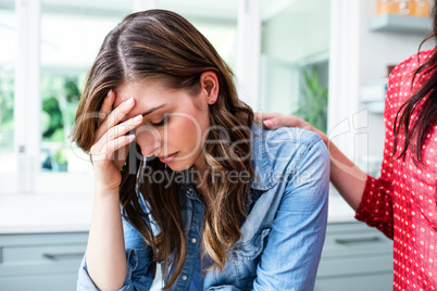 Sad young woman with friend