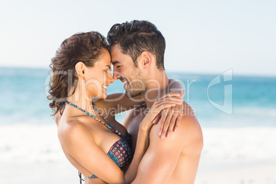 Happy couple hugging on the beach