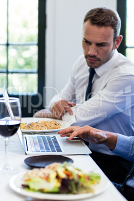 Businessmen discussing during a business lunch meeting