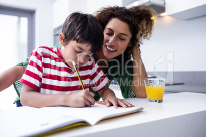 Mother helping son with homework