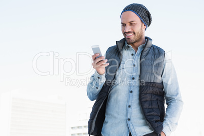 Young man text messaging on mobile phone