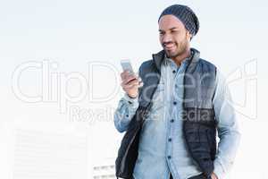 Young man text messaging on mobile phone