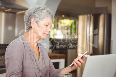 Senior woman holding mobile phone