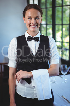 Waitress posing with crossed arms