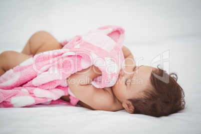 High angle view of baby holding blanket