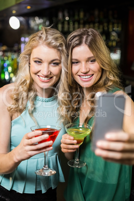 Smiling friends taking a selfie