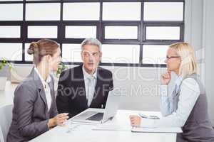 Business people with client in meeting room