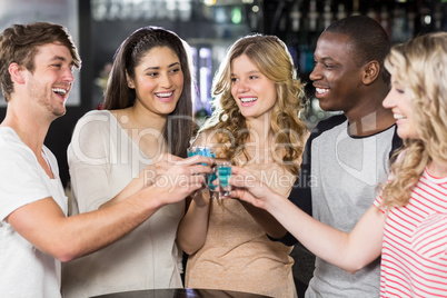 Friends toasting with shots