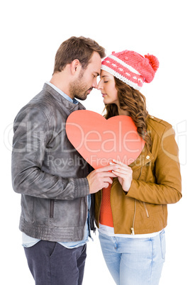 Young couple holding big heart