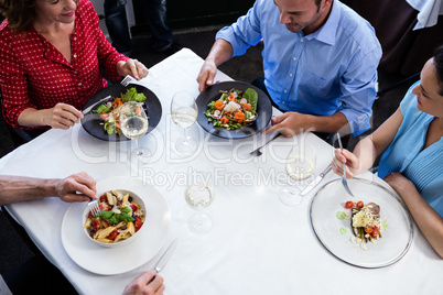 Group of friends talking while having lunch