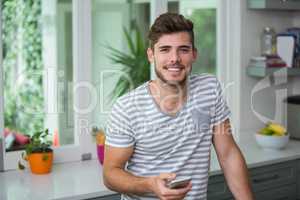 Portrait of smiling man holding phone