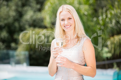 Portrait of smiling woman holding champagne flute
