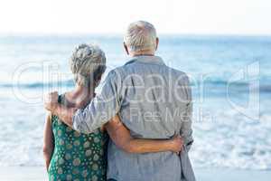 Senior couple facing the sea