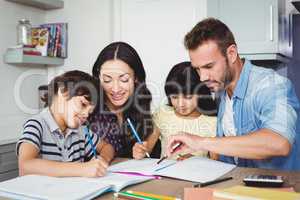 Parents assisting children doing homework