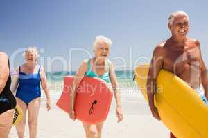 Senior friends holding surfboard