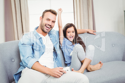 Portrait of father and daughter on sofa