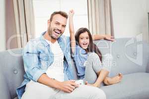 Portrait of father and daughter on sofa