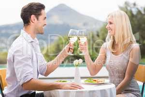 Couple toasting white wine