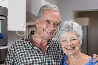 Elderly man and woman standing in kitchen