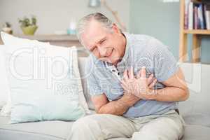 Senior man laughing  while sitting on sofa