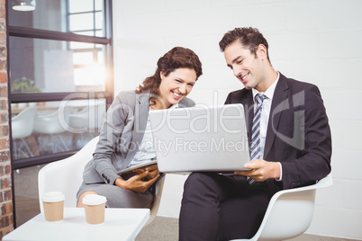 Cheerful business people using technology