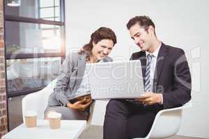 Cheerful business people using technology