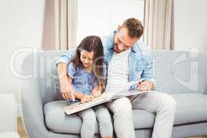 Father and daughter reading book