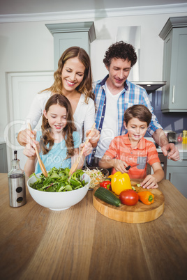 Young couple with children in kitchen